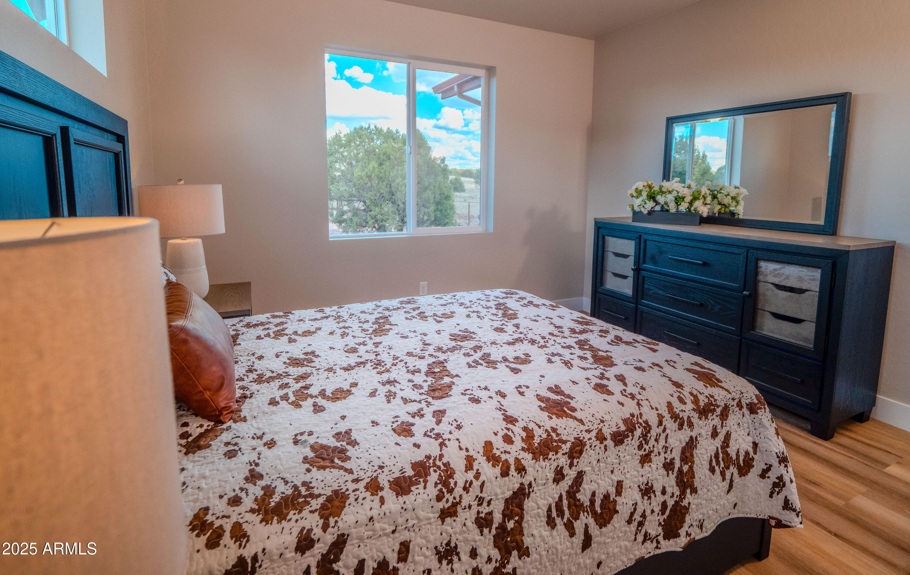 941 South Ridgeway Place Show Low, AZ 85901 - Photo 44 of 67 a bedroom with a bed and a dresser next to a window