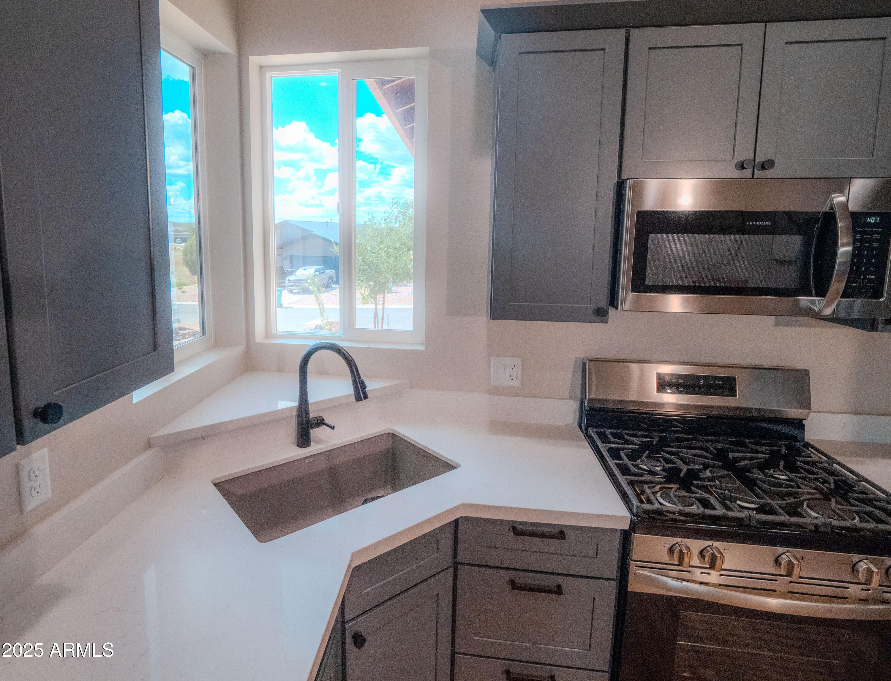 941 South Ridgeway Place Show Low, AZ 85901 - Photo 10 of 67 a kitchen with kitchen island granite countertop a sink stainless steel appliances and window