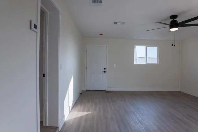 wooden floor in an empty room with a window
