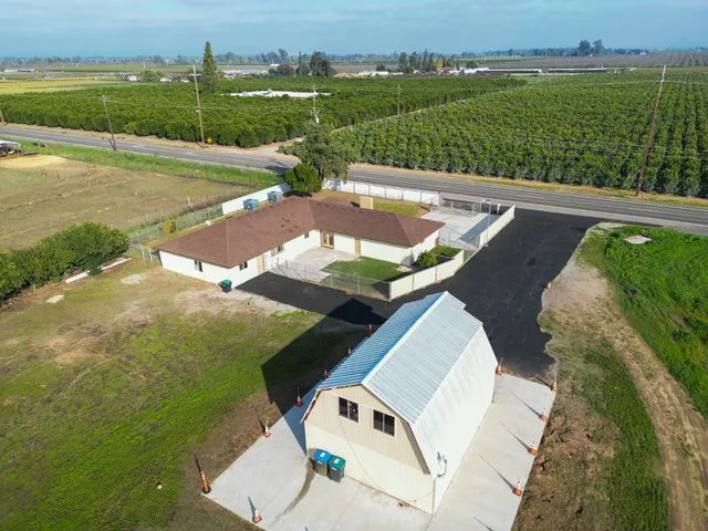 an aerial view of a house with a yard