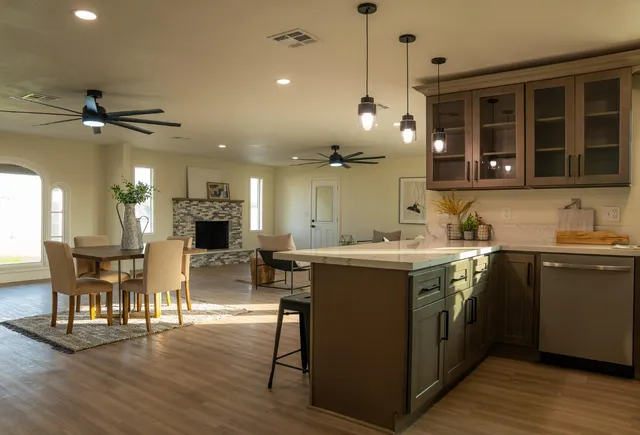 an open kitchen with wooden floor and large cabinets