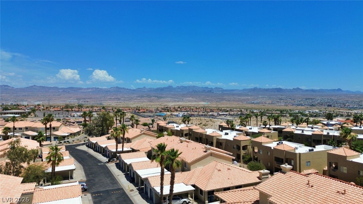 2243 Rugged Mesa Drive Laughlin, NV 89029 - Photo 6 of 32 An aerial panorama reveals a community of homes nestled against a vast desert and mountain backdrop.