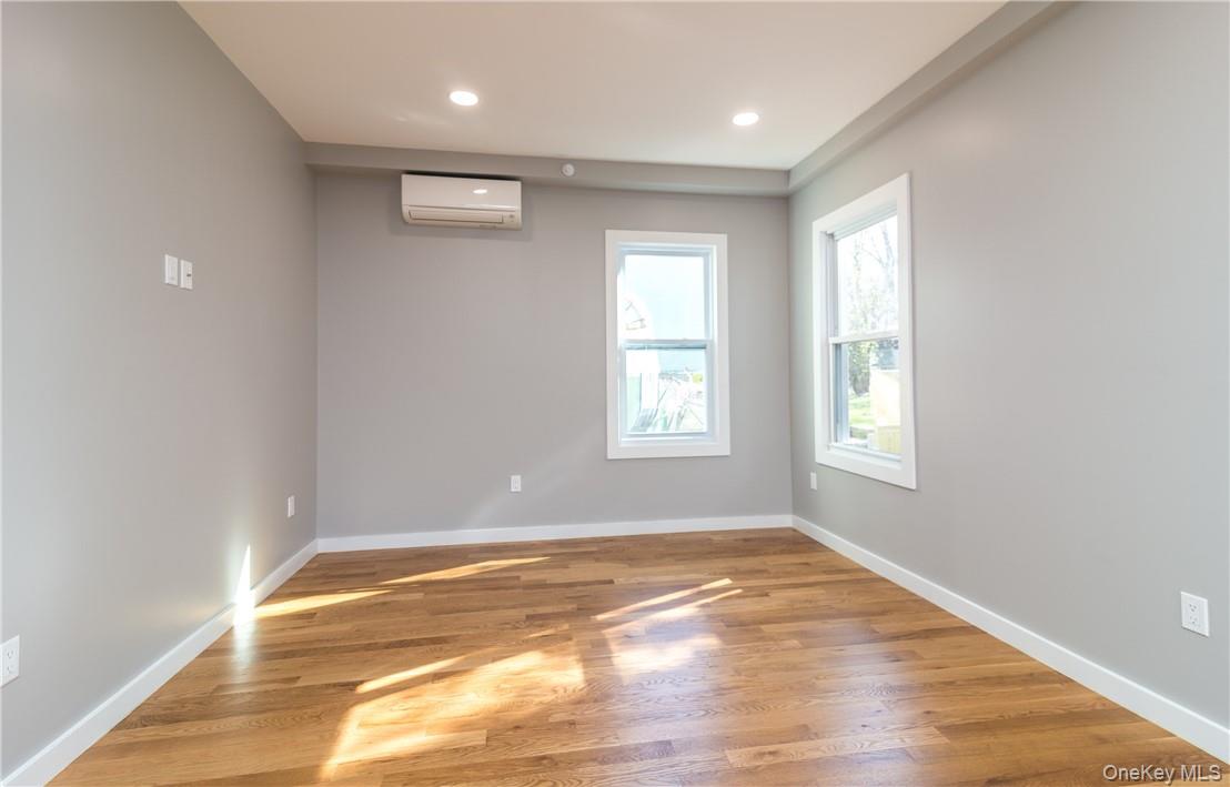 86 Main Street, Unit 3 Dobbs Ferry, NY 10522 - Photo 13 of 24 an empty room with wooden floor and windows