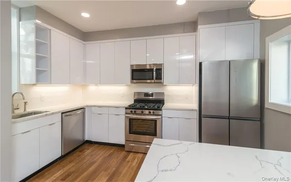 a kitchen with a refrigerator stove and microwave