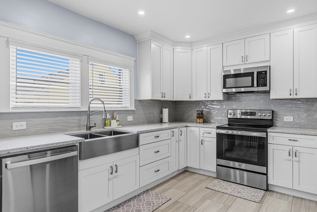 372 Buffinton Street Somerset, MA 02726 - Photo 2 of 33 a kitchen with stainless steel appliances granite countertop a sink and cabinets
