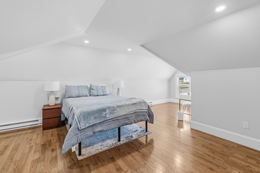 372 Buffinton Street Somerset, MA 02726 - Photo 27 of 33 a bedroom with a bed and wooden floor