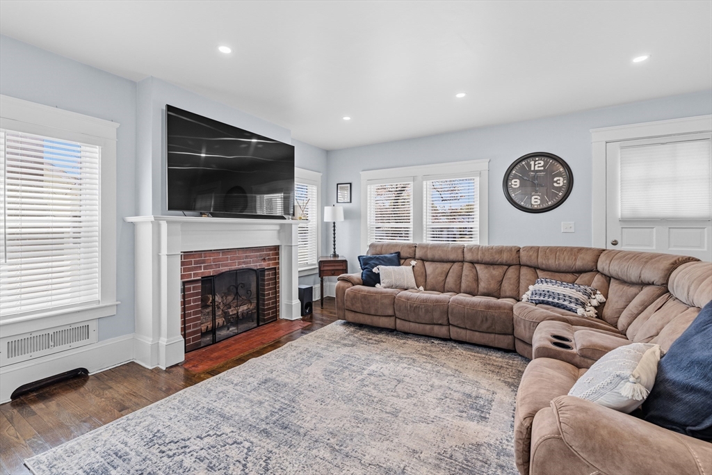 372 Buffinton Street Somerset, MA 02726 - Photo 4 of 33 a living room with furniture a flat screen tv and a fireplace