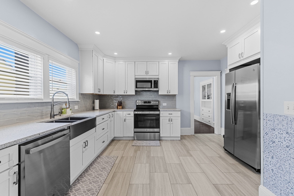 372 Buffinton Street Somerset, MA 02726 - Photo 6 of 33 a kitchen with a refrigerator a sink and a stove top oven