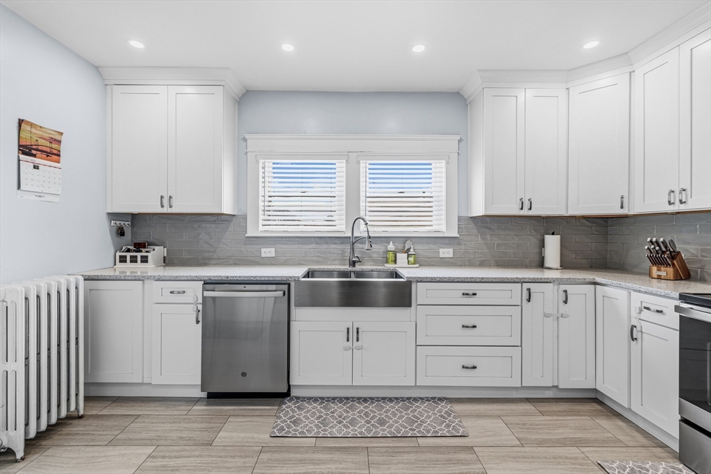372 Buffinton Street Somerset, MA 02726 - Photo 7 of 33 a kitchen with granite countertop white cabinets white appliances with a sink and dishwasher