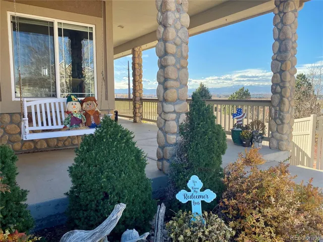 a front view of a house with a yard balcony and seating space