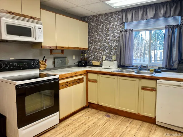 a view of a yard with table and chairs in patio