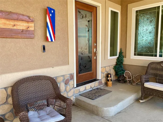 a view of an entryway with wooden floor and front door