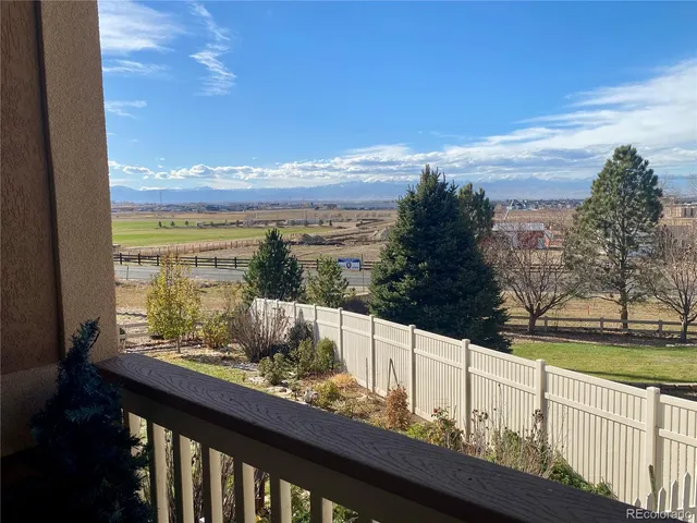 a view of a a dining room with furniture window and wooden floor