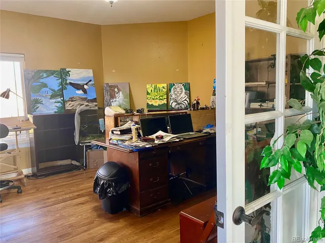 a living room with furniture fireplace and a large window