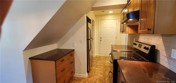 a kitchen with stainless steel appliances granite countertop a stove and a refrigerator