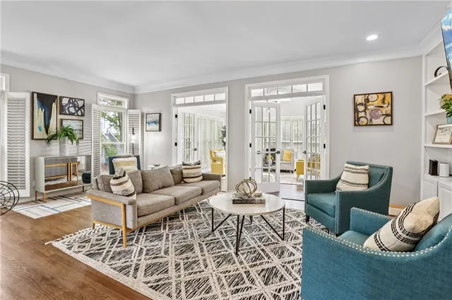 a living room with furniture and floor to ceiling windows