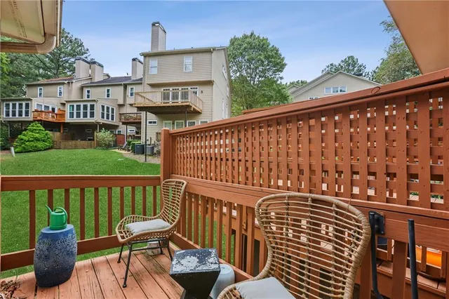 a kitchen with stainless steel appliances granite countertop a stove a sink dishwasher a microwave oven with a dining table and chairs