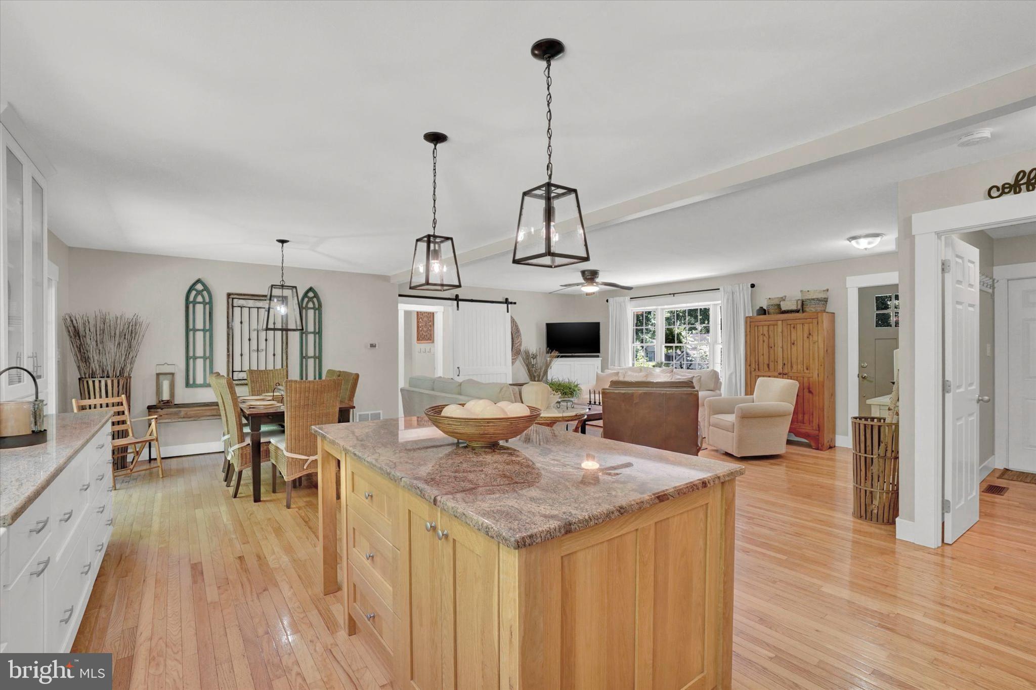 669 Woodburne Road Lewisberry, PA 17339 - Photo 13 of 44 a view of a dining room and livingroom with furniture wooden floor a chandelier