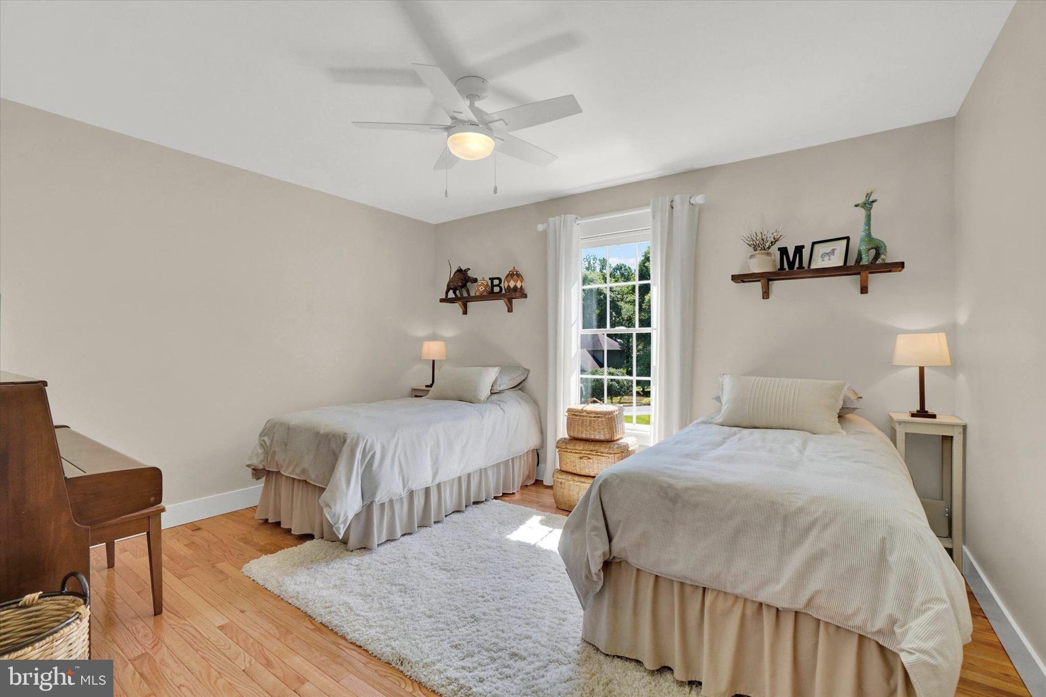 669 Woodburne Road Lewisberry, PA 17339 - Photo 15 of 44 a bedroom with a bed and wooden floor