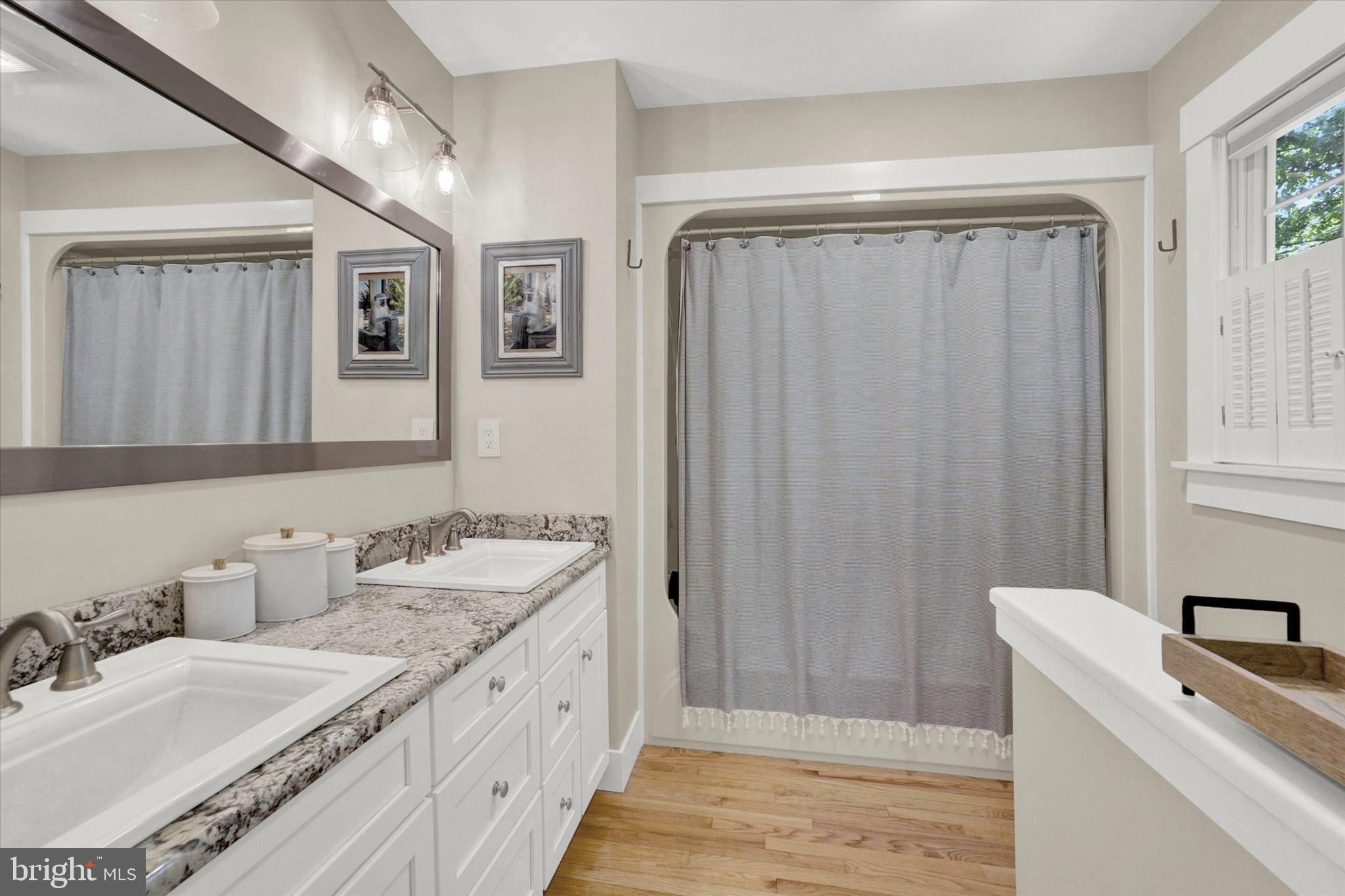 669 Woodburne Road Lewisberry, PA 17339 - Photo 21 of 44 a spacious bathroom with a granite countertop sink and a mirror
