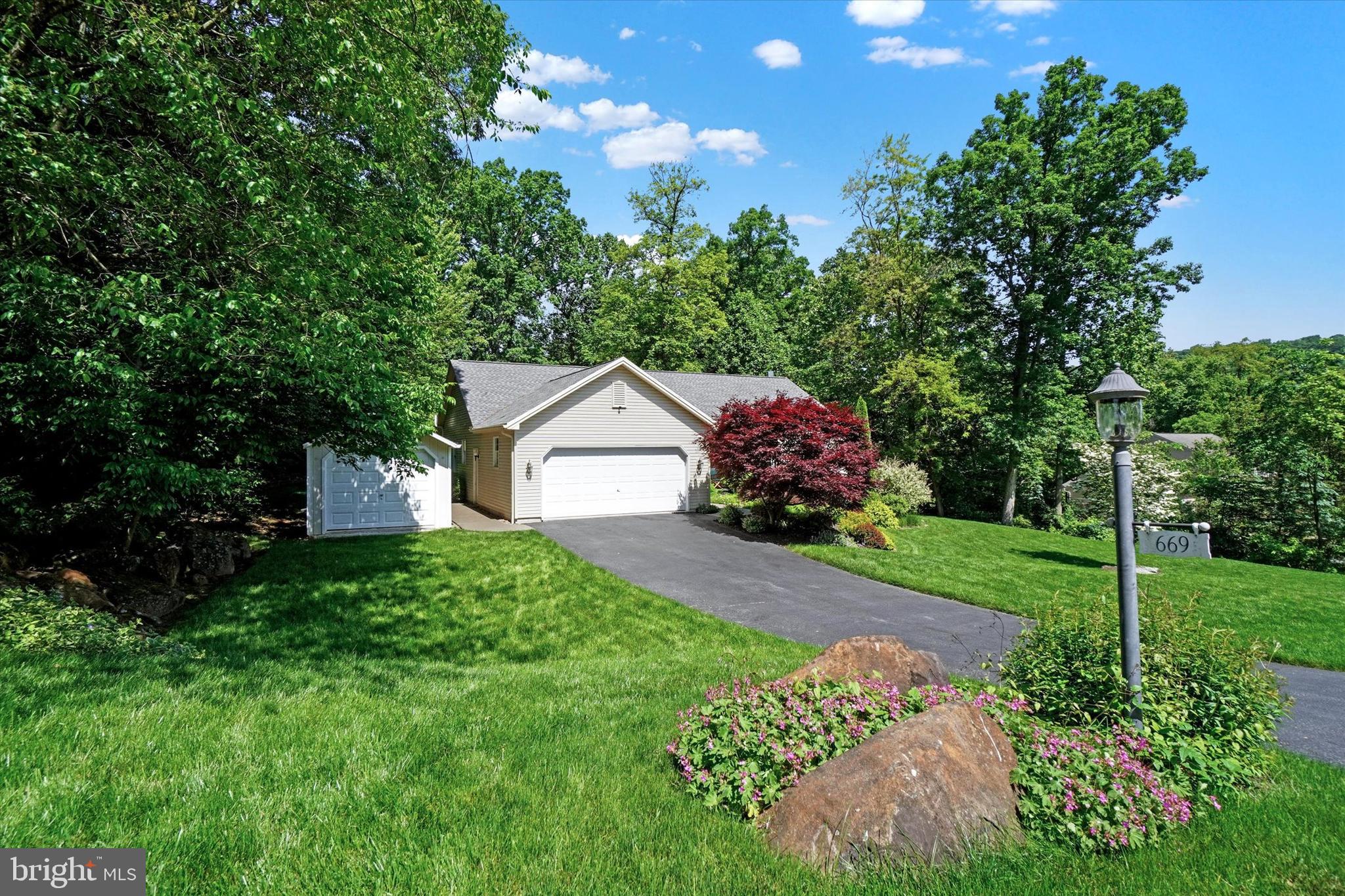 669 Woodburne Road Lewisberry, PA 17339 - Photo 3 of 44 a front view of a house with garden