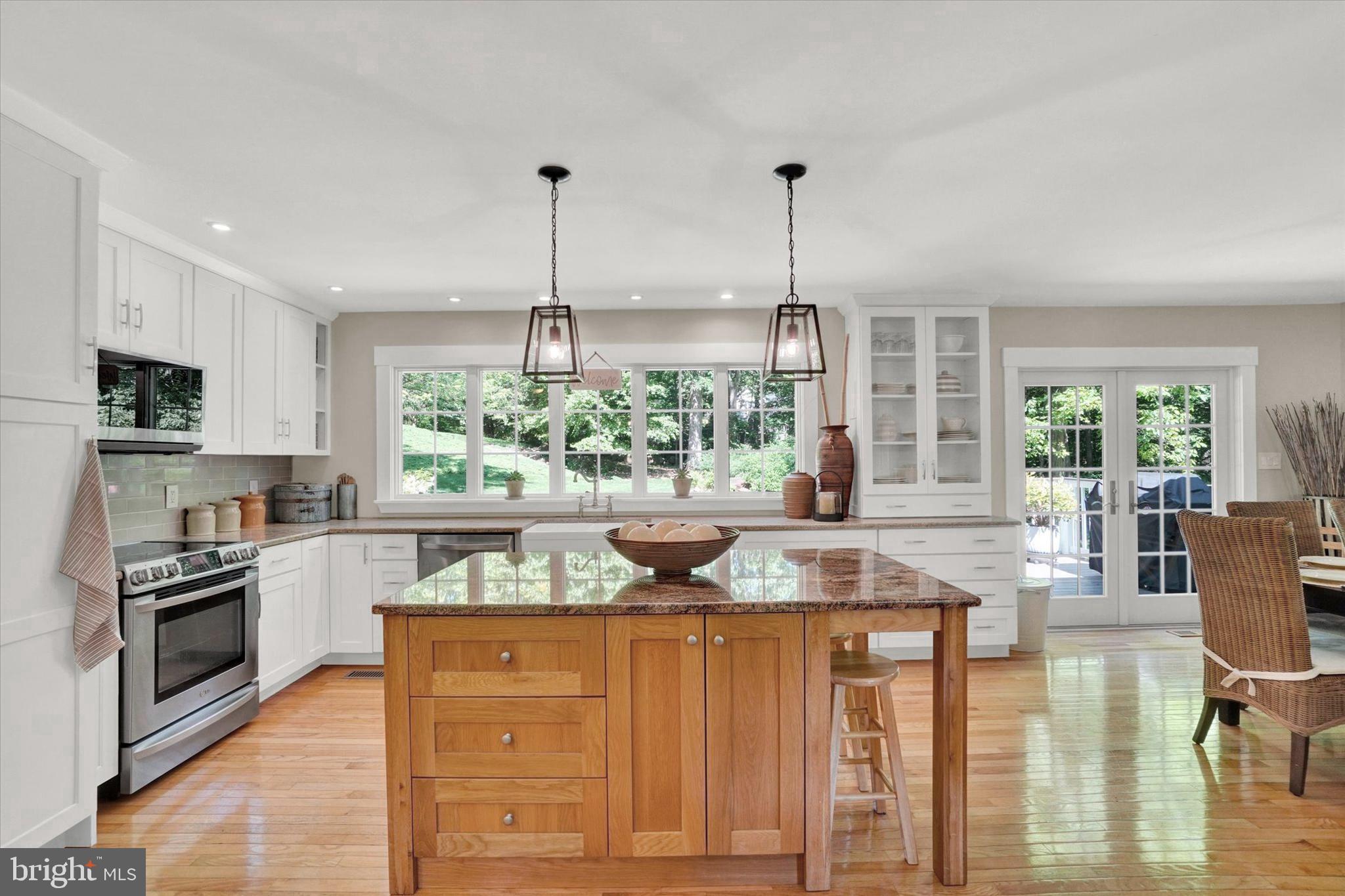 669 Woodburne Road Lewisberry, PA 17339 - Photo 8 of 44 a kitchen with granite countertop a stove and white cabinets