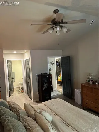 a bedroom with a bed and dresser with mirror
