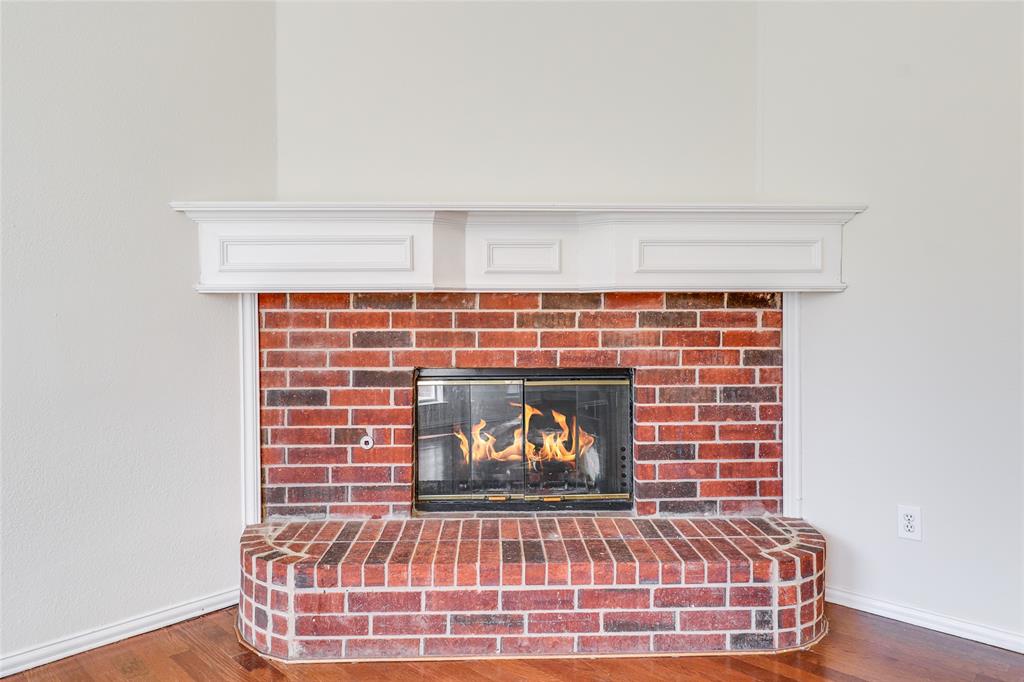 8100 Steamers Lane Frisco, TX 75035 - Photo 12 of 24 a view of fireplace with wooden floor