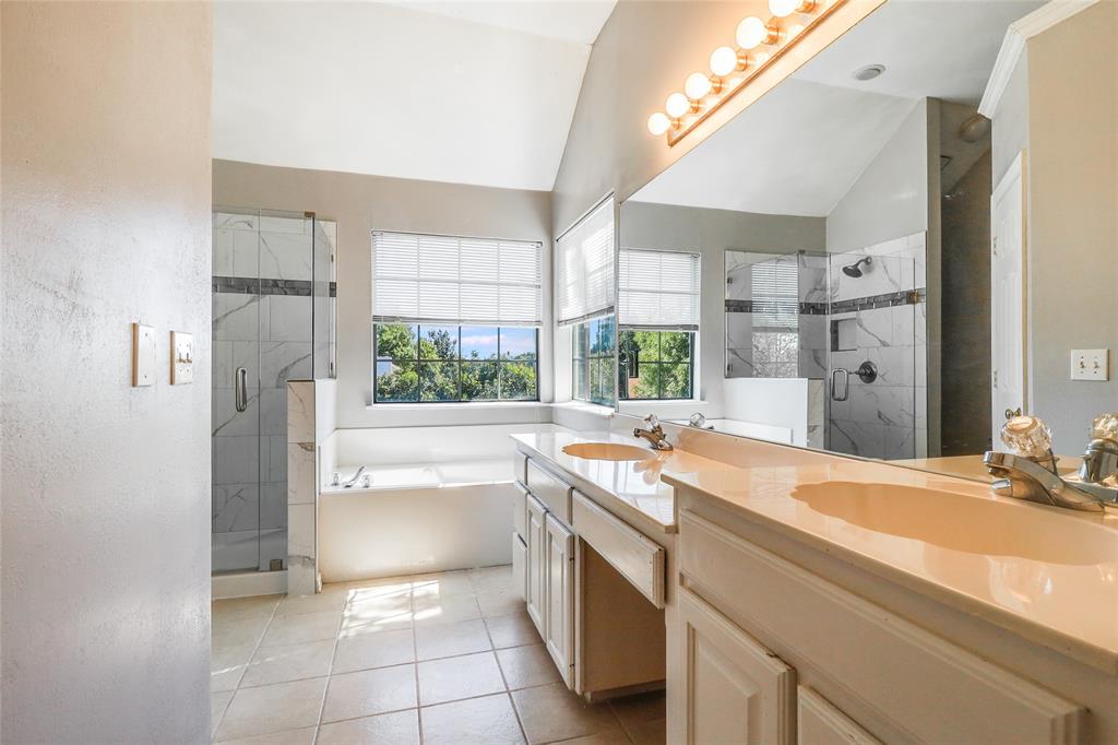 8100 Steamers Lane Frisco, TX 75035 - Photo 15 of 24 a bathroom with a granite countertop sink mirror and a bathtub