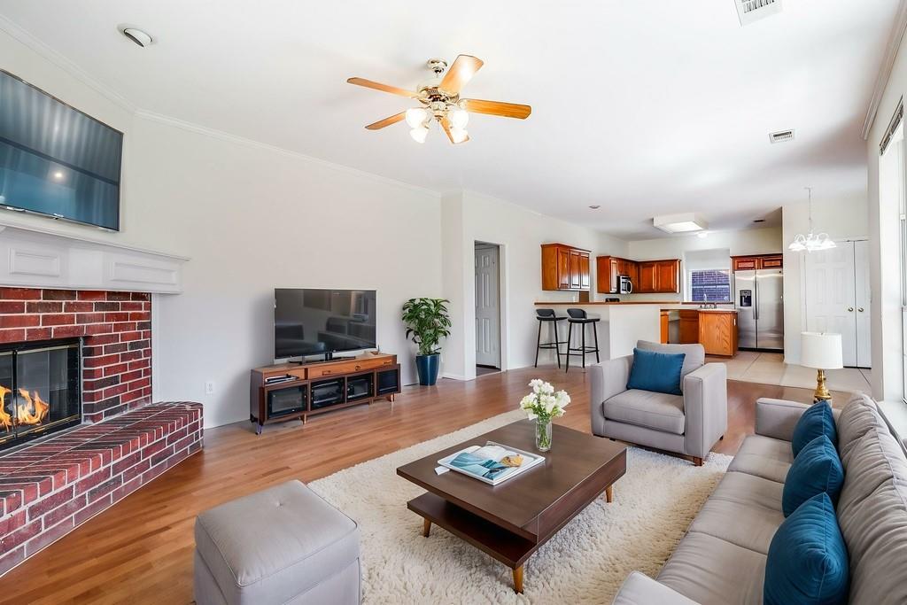 8100 Steamers Lane Frisco, TX 75035 - Photo 3 of 24 a living room with furniture and a fireplace