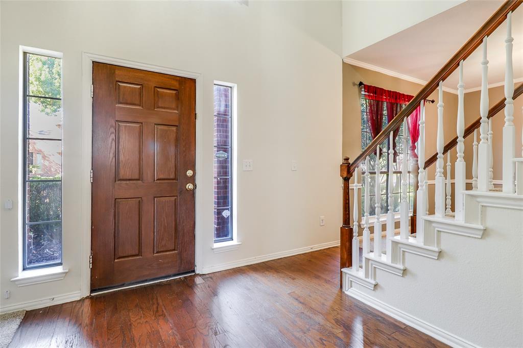 8100 Steamers Lane Frisco, TX 75035 - Photo 5 of 24 an entryway with wooden floor and door