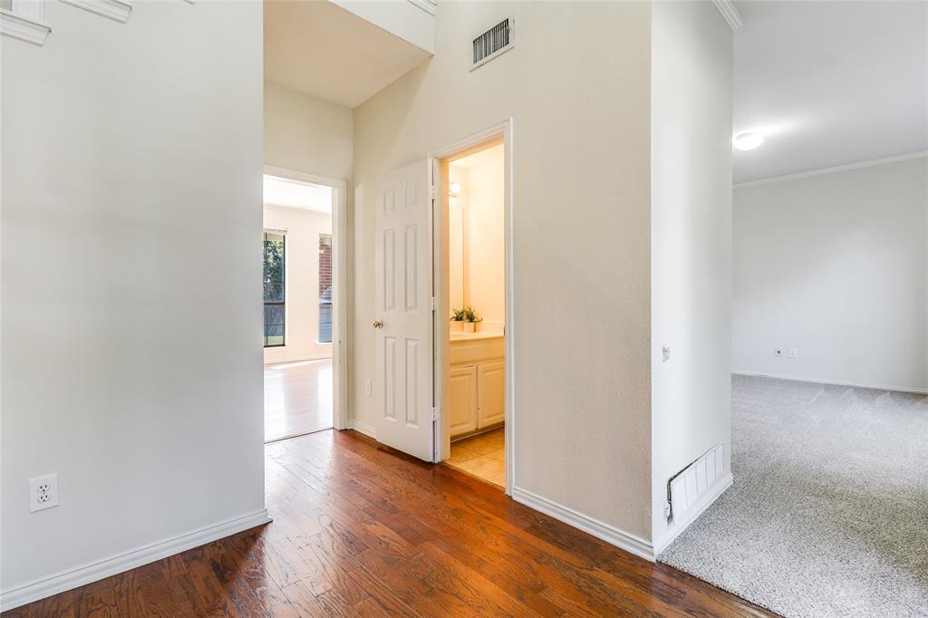 8100 Steamers Lane Frisco, TX 75035 - Photo 10 of 24 an empty room with wooden floor and windows