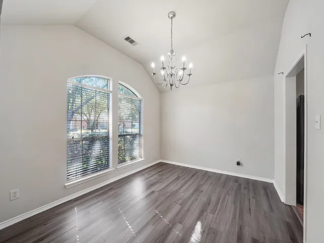 a view of livingroom with chandelier and wooden floor