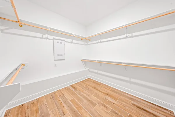 a view of a room with wooden floor and cabinet