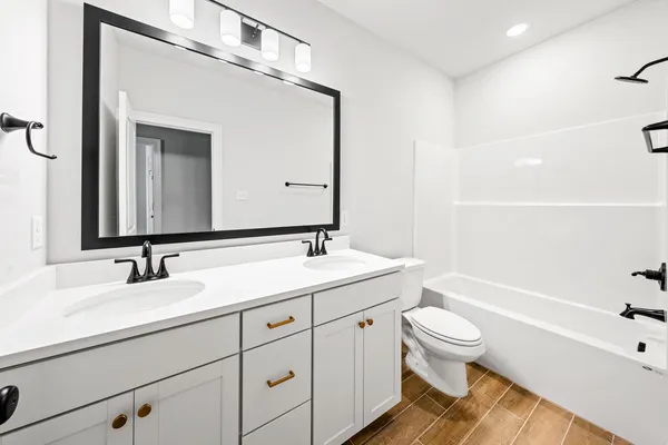 a bathroom with a sink a toilet and bathtub