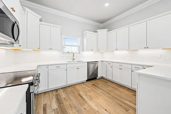 a kitchen with a sink cabinets and window