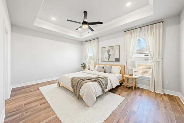 a bedroom with a bed and wooden floor
