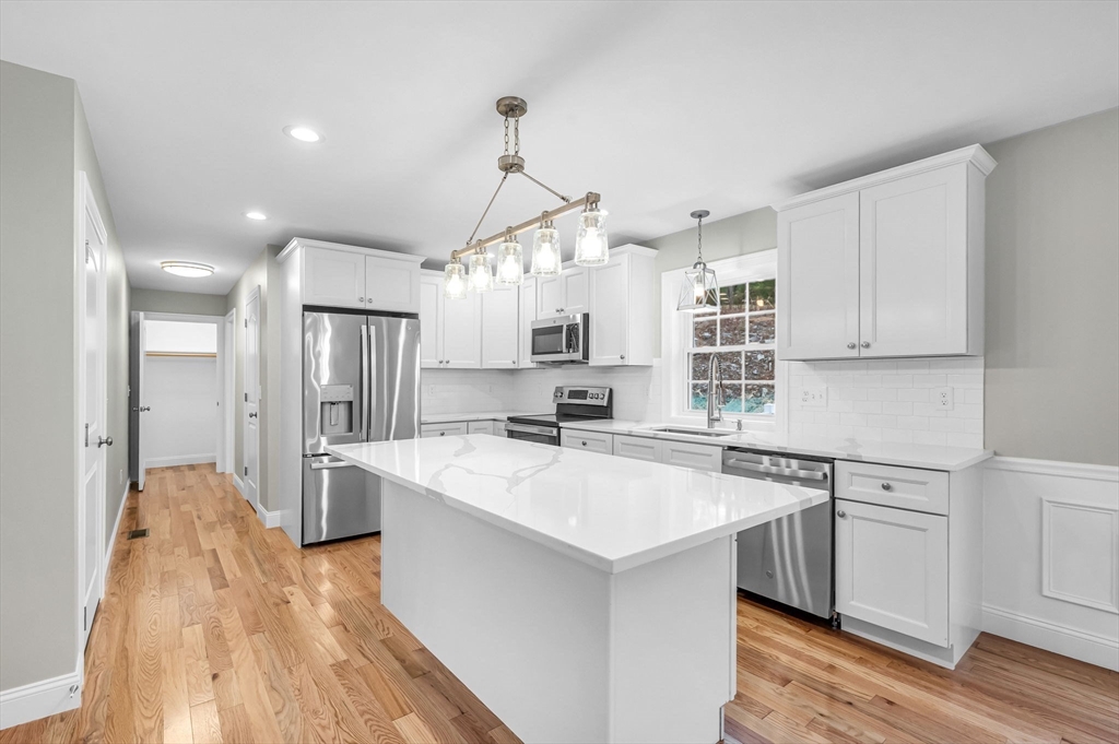 6 High Blf Road Belchertown, MA 01007 - Photo 15 of 42 a kitchen with kitchen island a sink a stove a refrigerator and white cabinets
