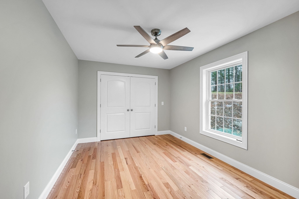 6 High Blf Road Belchertown, MA 01007 - Photo 30 of 42 a view of an empty room with wooden floor and a window