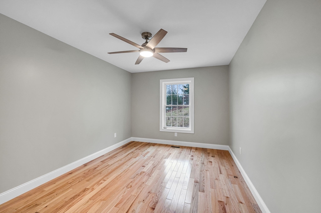 6 High Blf Road Belchertown, MA 01007 - Photo 32 of 42 an empty room with wooden floor fan and windows