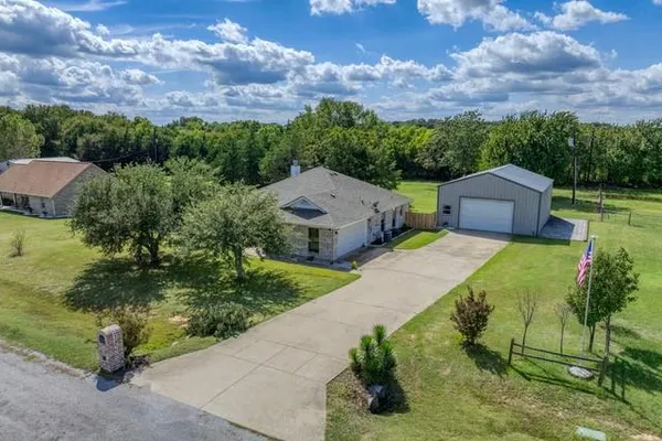 an aerial view of a house with a garden and a yard