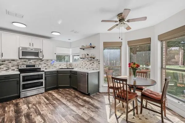 a kitchen with a refrigerator and a stove