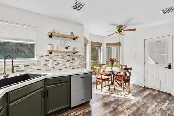 a view of a kitchen with a dining table and chairs
