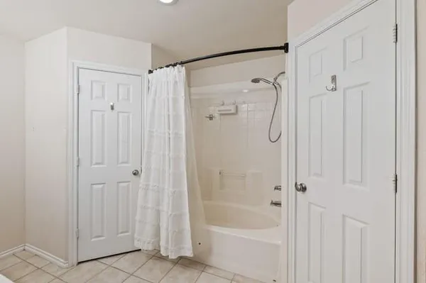a bathroom with a glass shower door