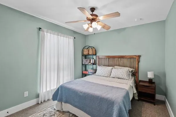 a bedroom with a large bed and a chandelier