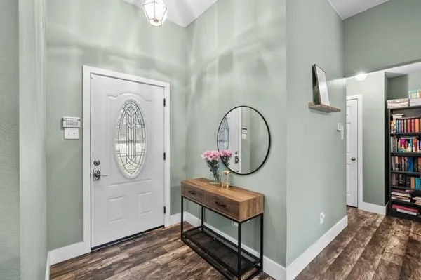 a area with painting on the wall and a mirror