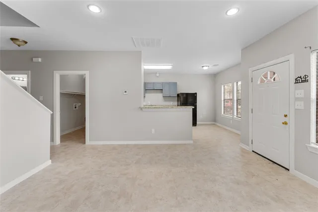 a view of a kitchen with refrigerator and a sink