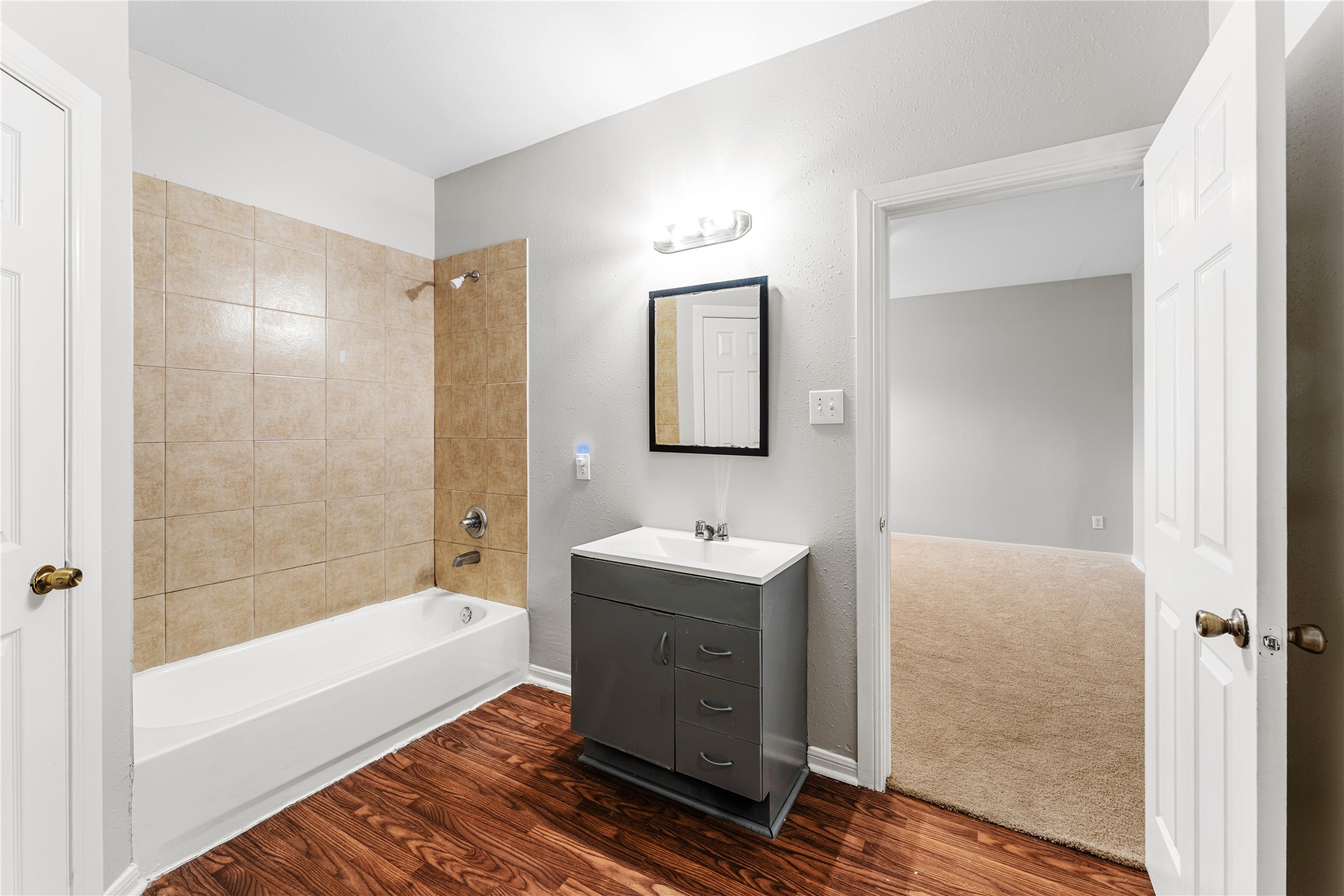 9610 Buffum Street, Unit B Houston, TX 77051 - Photo 18 of 25 a bathroom with a tub sink and mirror