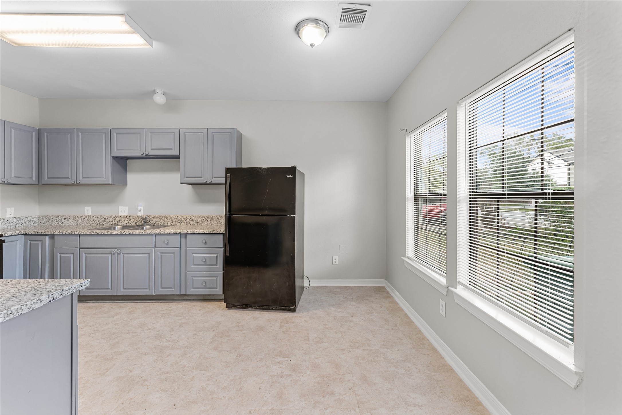 9610 Buffum Street, Unit B Houston, TX 77051 - Photo 4 of 25 a kitchen with a refrigerator and a sink