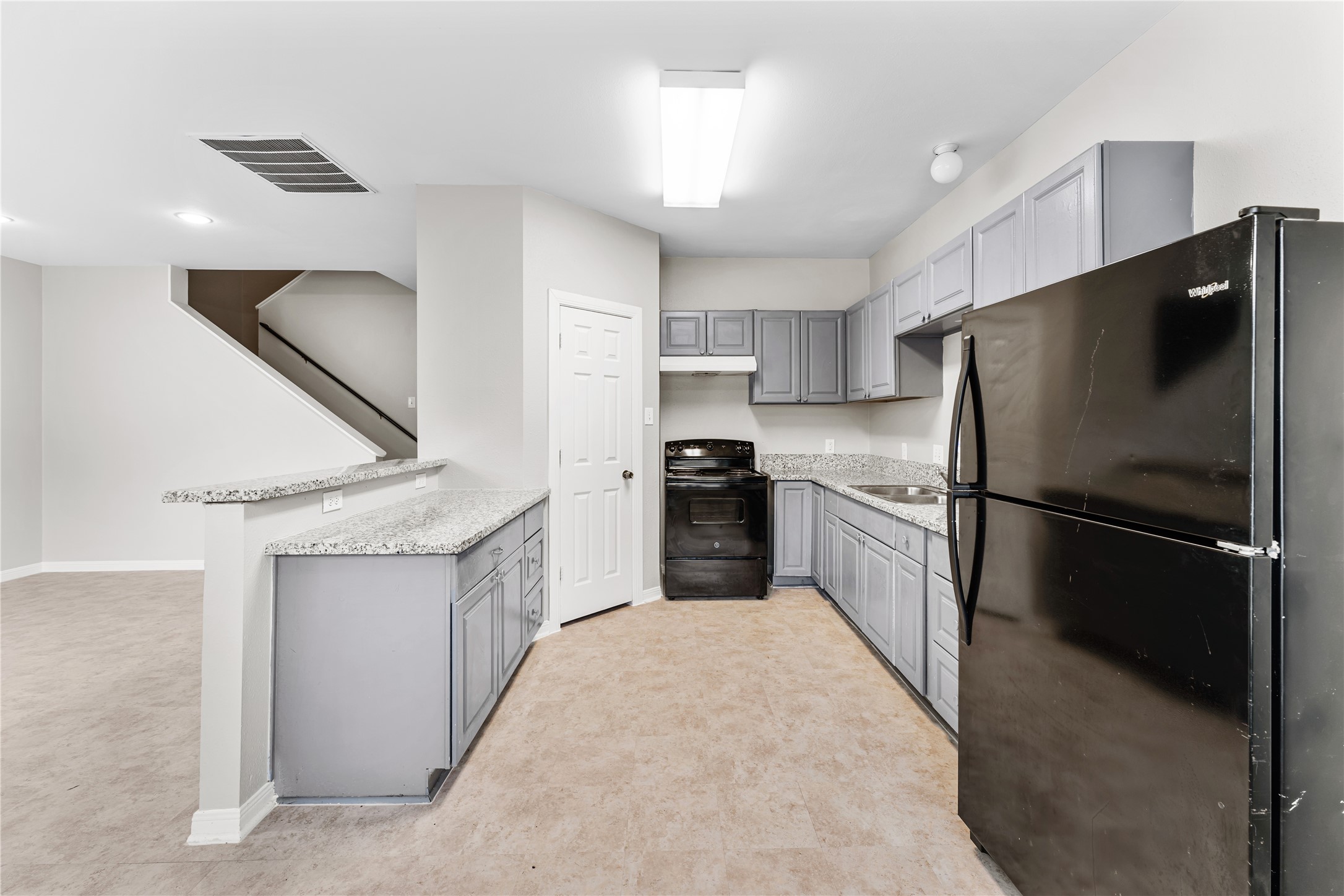 9610 Buffum Street, Unit B Houston, TX 77051 - Photo 5 of 25 a kitchen with a refrigerator a sink and a oven